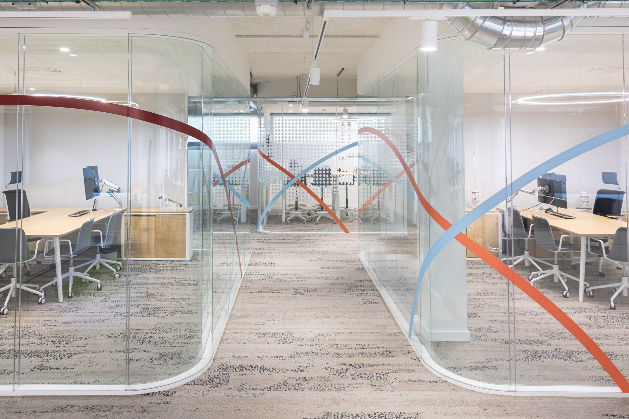 Zona de recepción en oficinas corporativas con interiorismo moderno y funcional